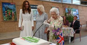 Queen Elizabeth Playfully Snaps at Aide While Cutting Cake With Sword