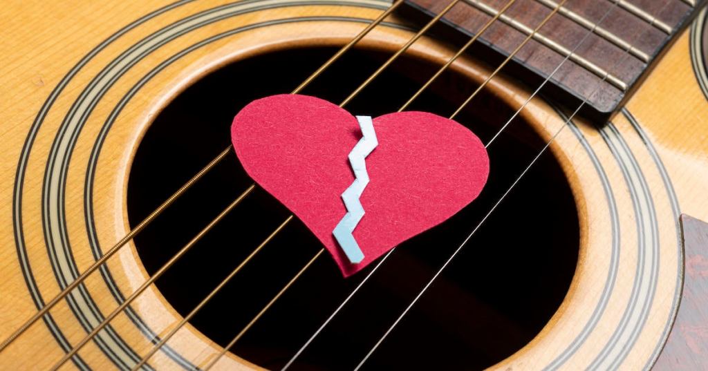 Close-Up Of broken heart on acoustic guitar.Studio Shot