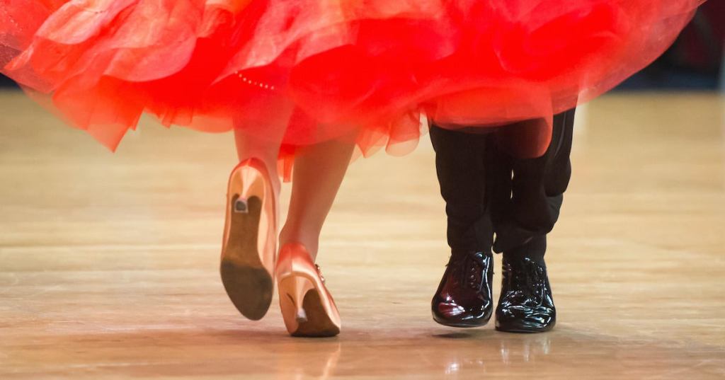 Low Section Of Couple Dancing On Hardwood Floor