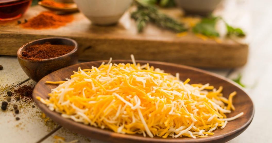 shredded-cheese-on-wooden-plate.jpg