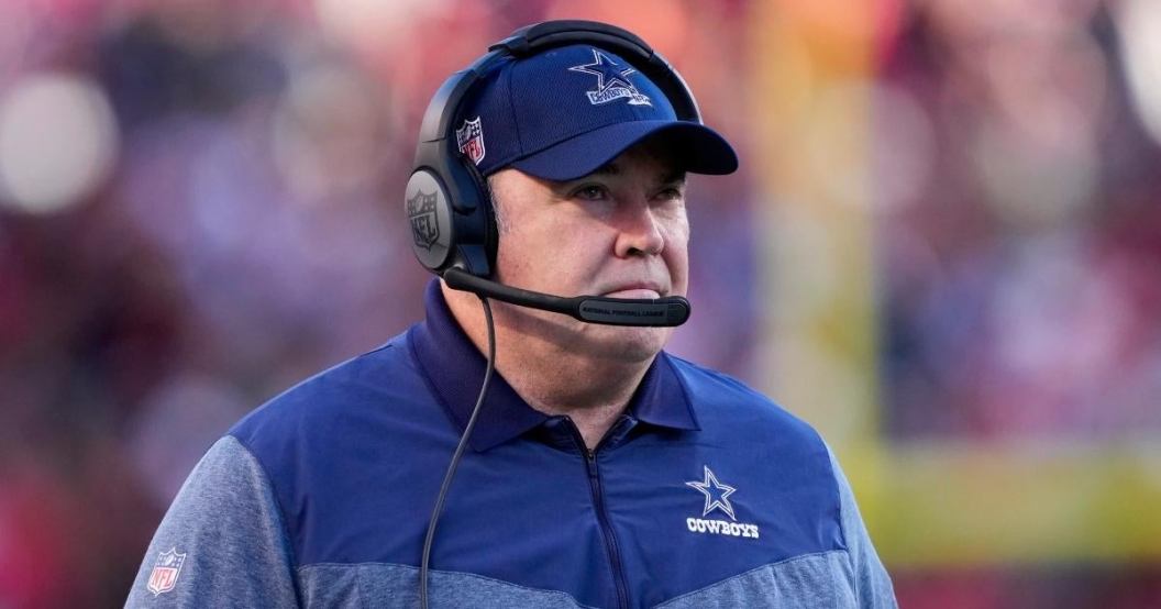 mike-mccarthy-cowboys-coach-stiff-arms-carmeraman.jpg