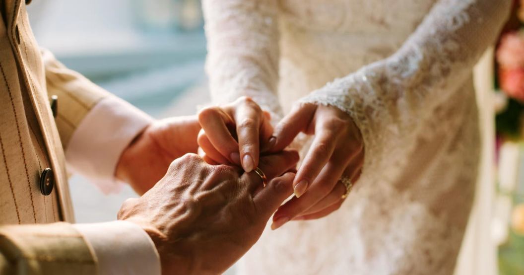 wedding-bride-putting-ring-on-grooms-finger.jpg
