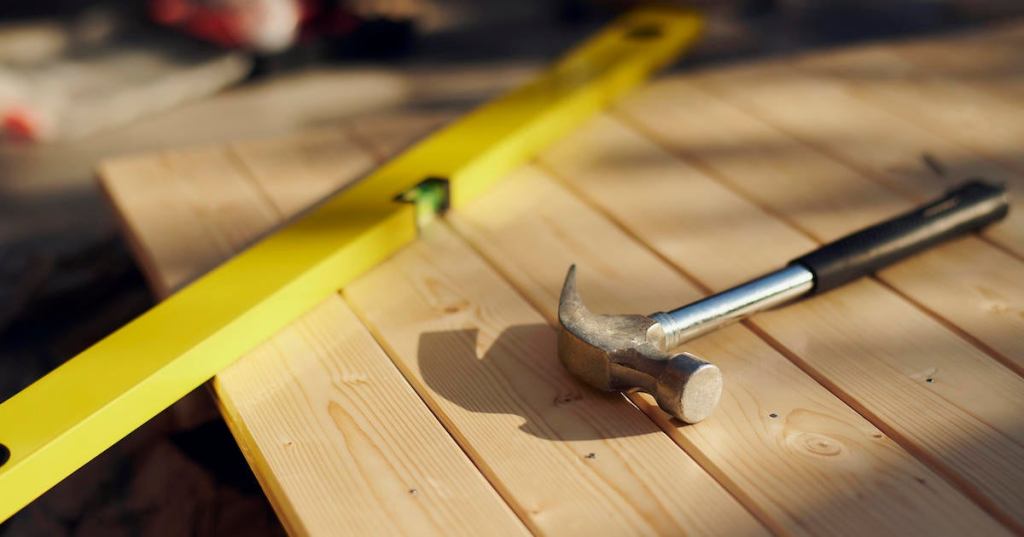 DIY work tools resting on wood in the sun