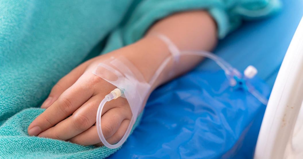hand-of-the-patient-is-on-drip-receiving-a-saline-solution-on-bed-vip-room-at-hospital.jpg