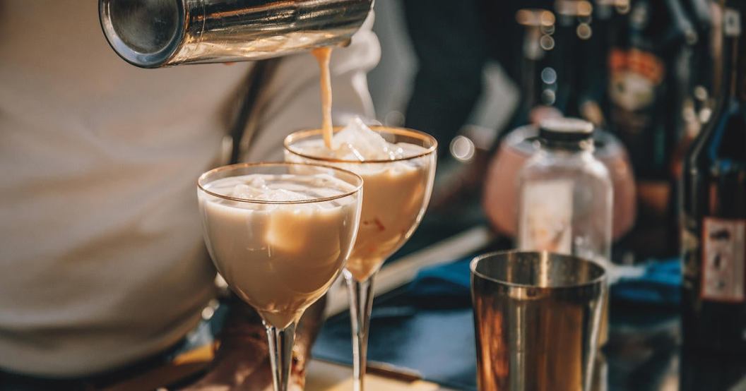 bartender-making-baileys-cocktail-with-ice-and-pouring-to-glass-from-bar-shaker.jpg