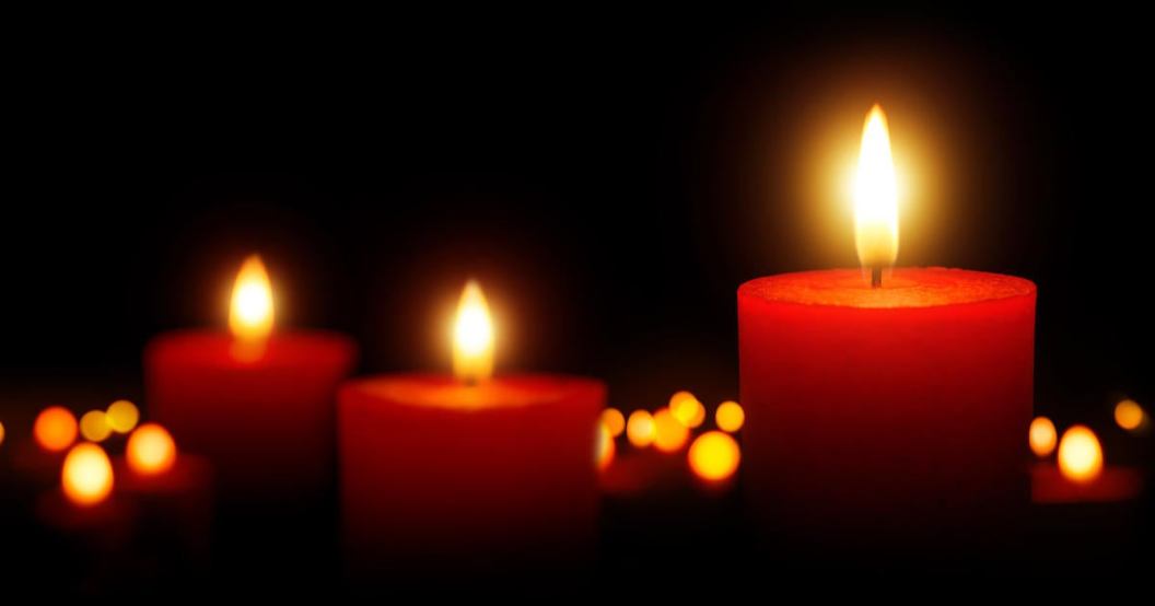 Burning candles gently glowing in the dark