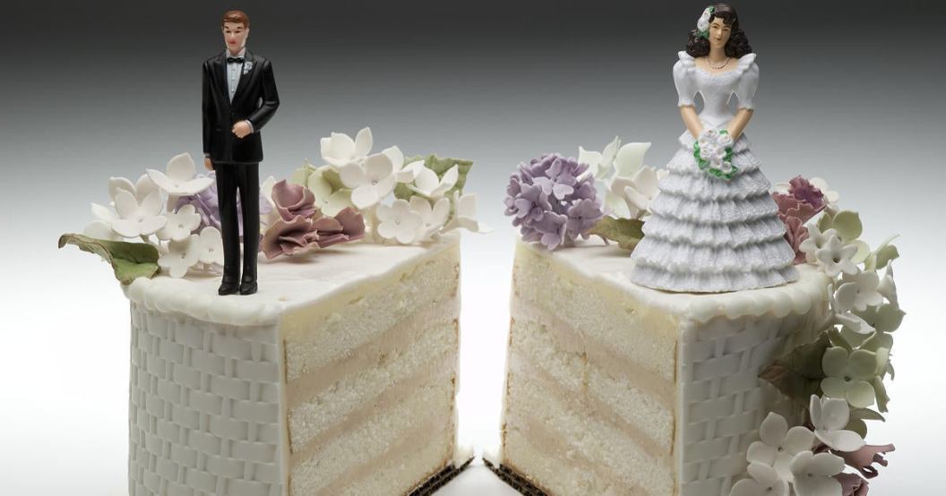 bride-and-groom-figurines-standing-on-two-separated-slices-of-wedding-cake.jpg