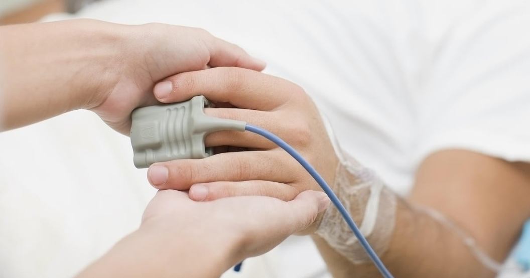 person-holding-patients-hand-in-hospital.jpg
