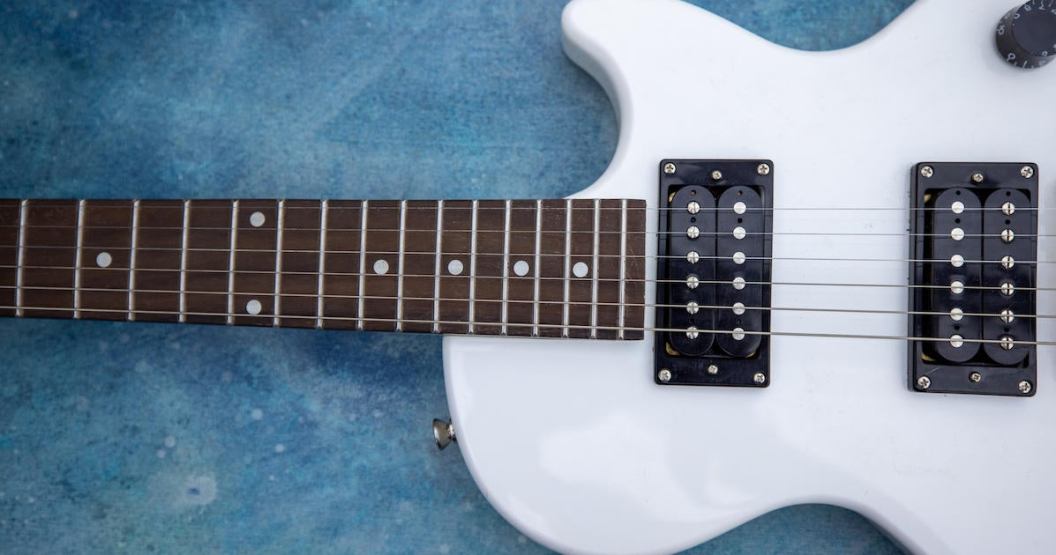 Beautiful vintage white electric guitar shape on a blue background
